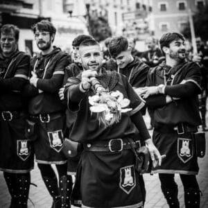 Grupo de hombres vestidos con trajes medievales en desfile.