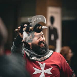 Hombre con armadura y espada, festividad medieval.
