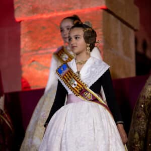 Niña en traje tradicional valenciano, ceremonia festiva.