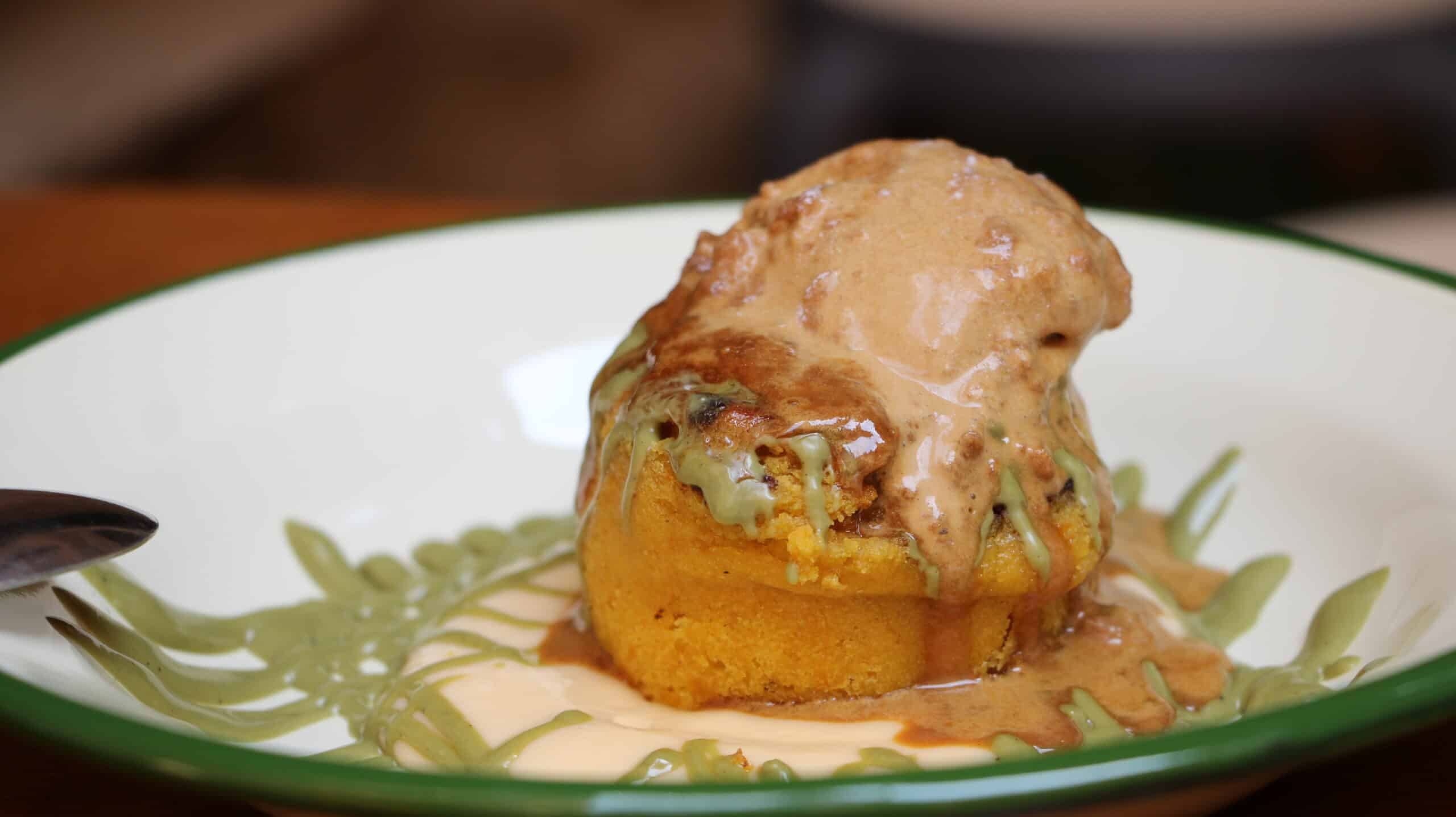 Bizcocho con salsas diversas en un plato blanco.